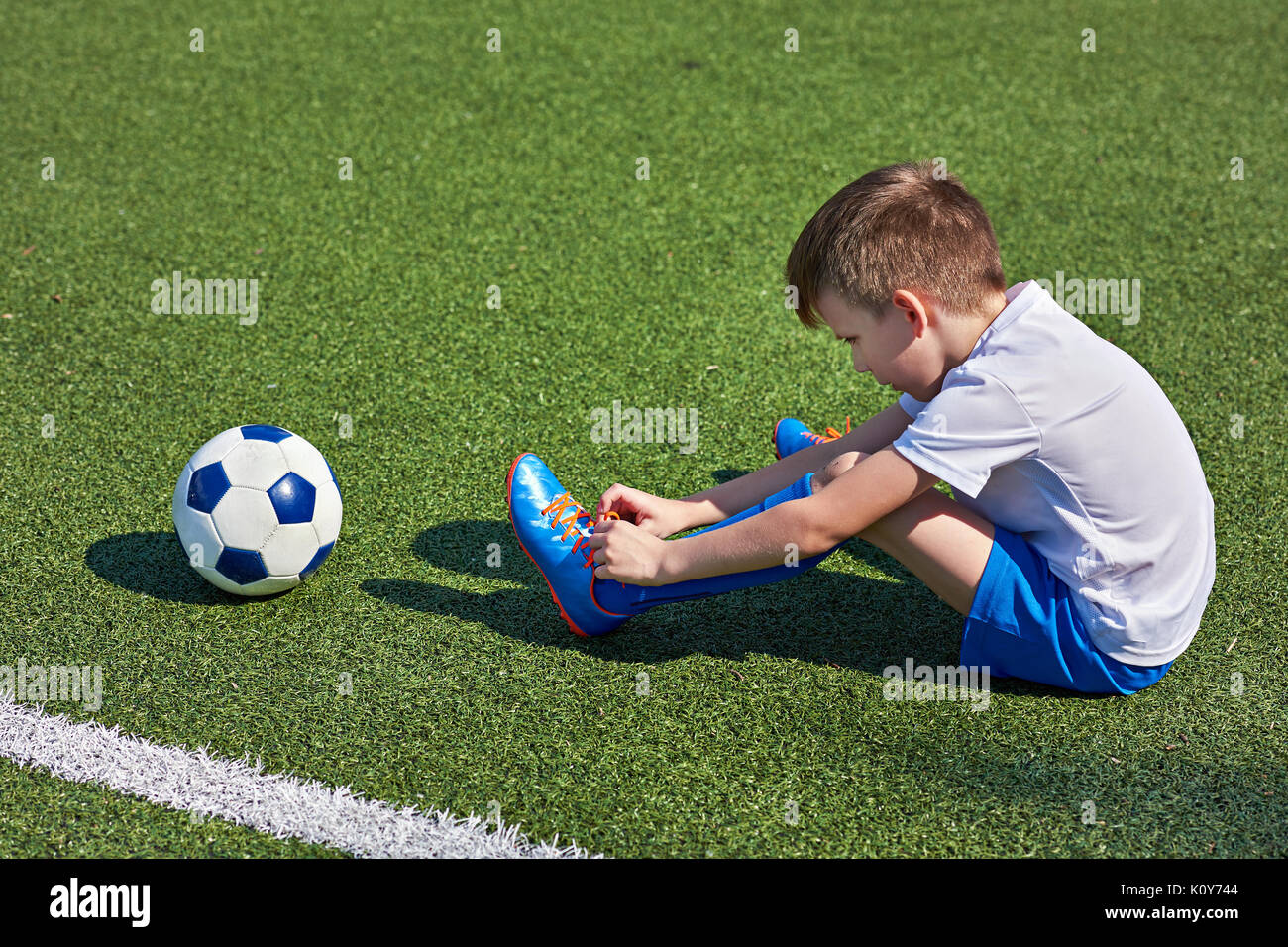 Boy tying shoe hi-res stock photography and images - Alamy