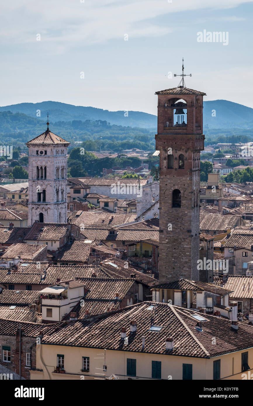 View to the clock tower Torre delle Ore and the church of San Michele in Foro, Lucca, Tuscany, Italy Stock Photo