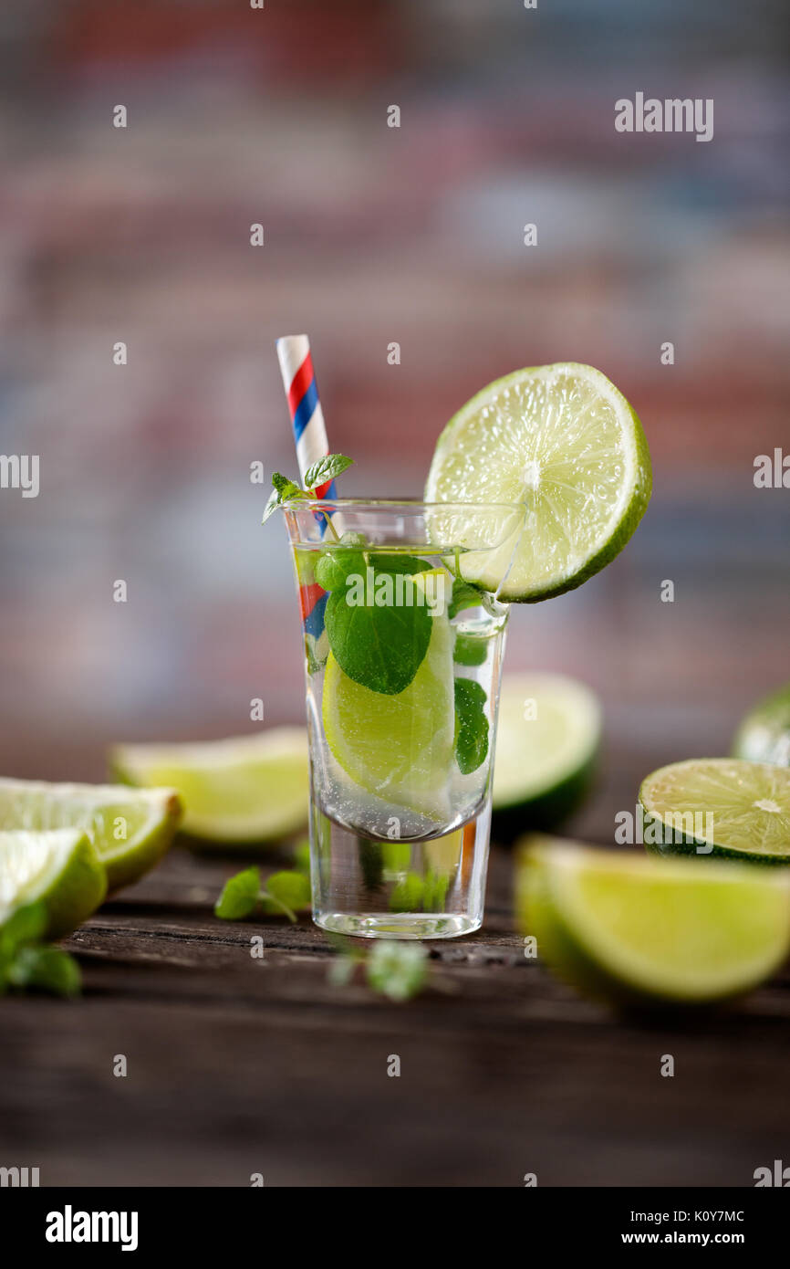 Summer cocktail with soda water, ice, lime and mint on wooden table Stock Photo