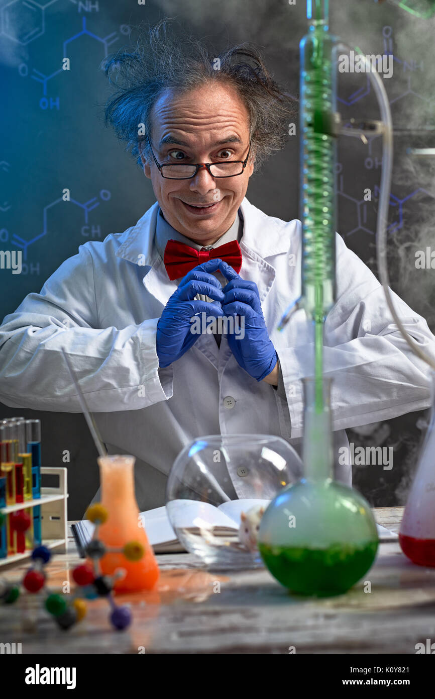 Happy crazy chemist looking in experiment that happens Stock Photo
