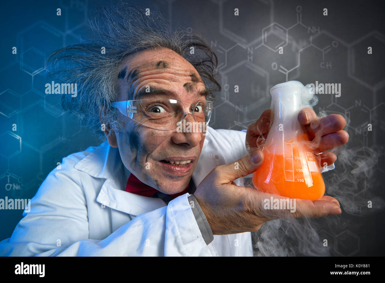 scientist with the dirty face of the explosion holding tube with chemicals Stock Photo