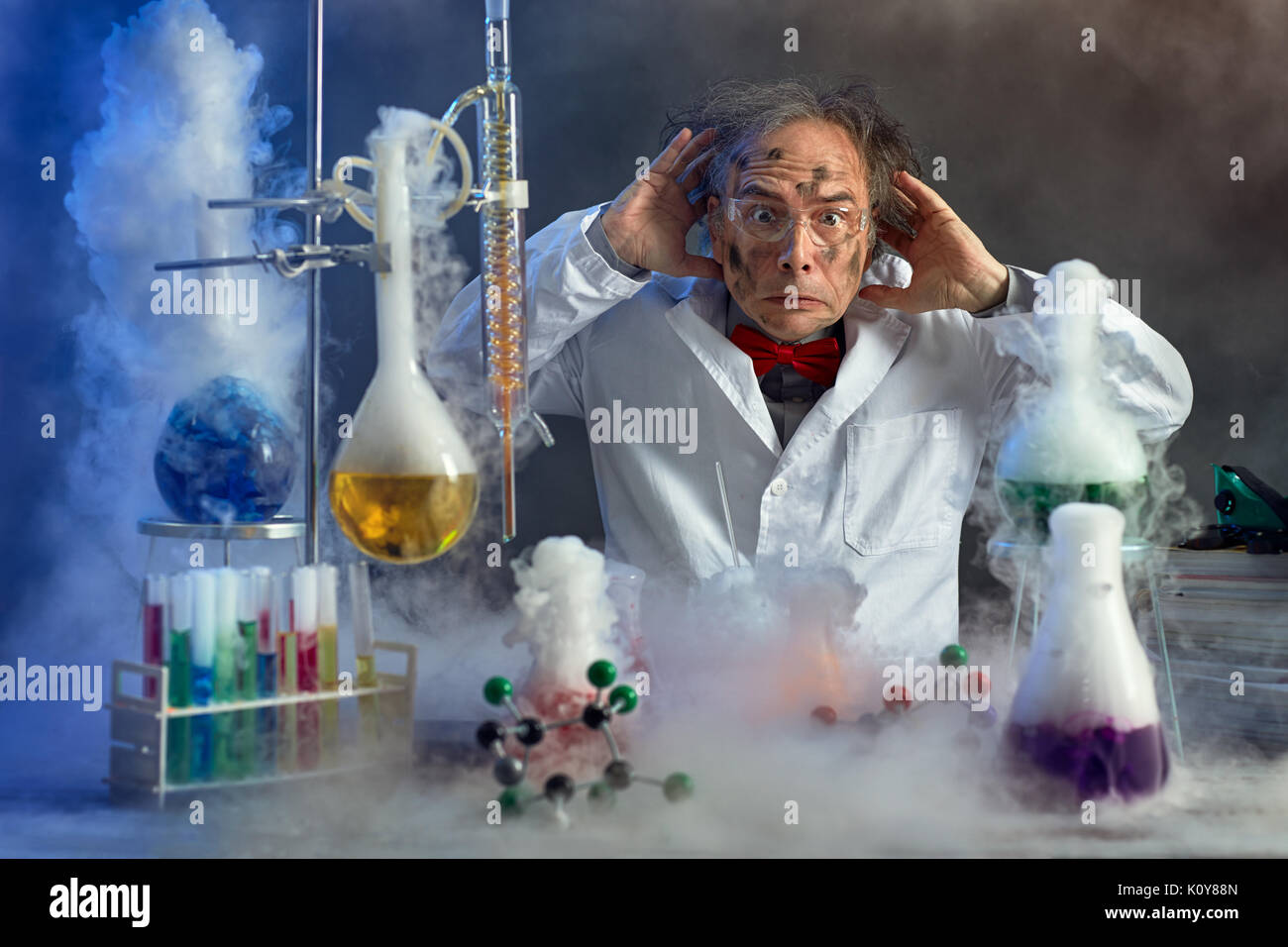 frightened scientist front of experiment that exploded in lab Stock Photo