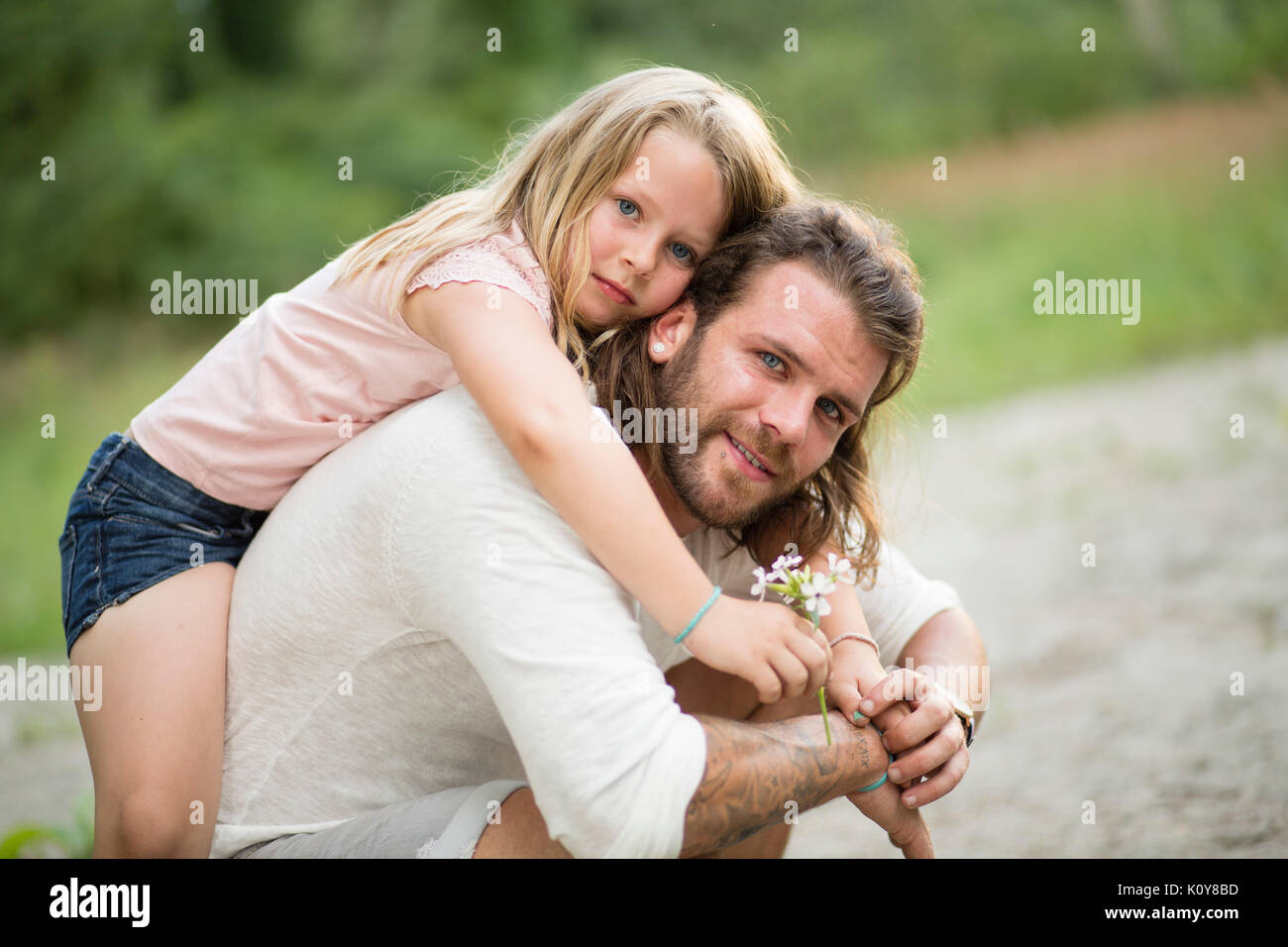 Father and daughter together in the forest Stock Photo