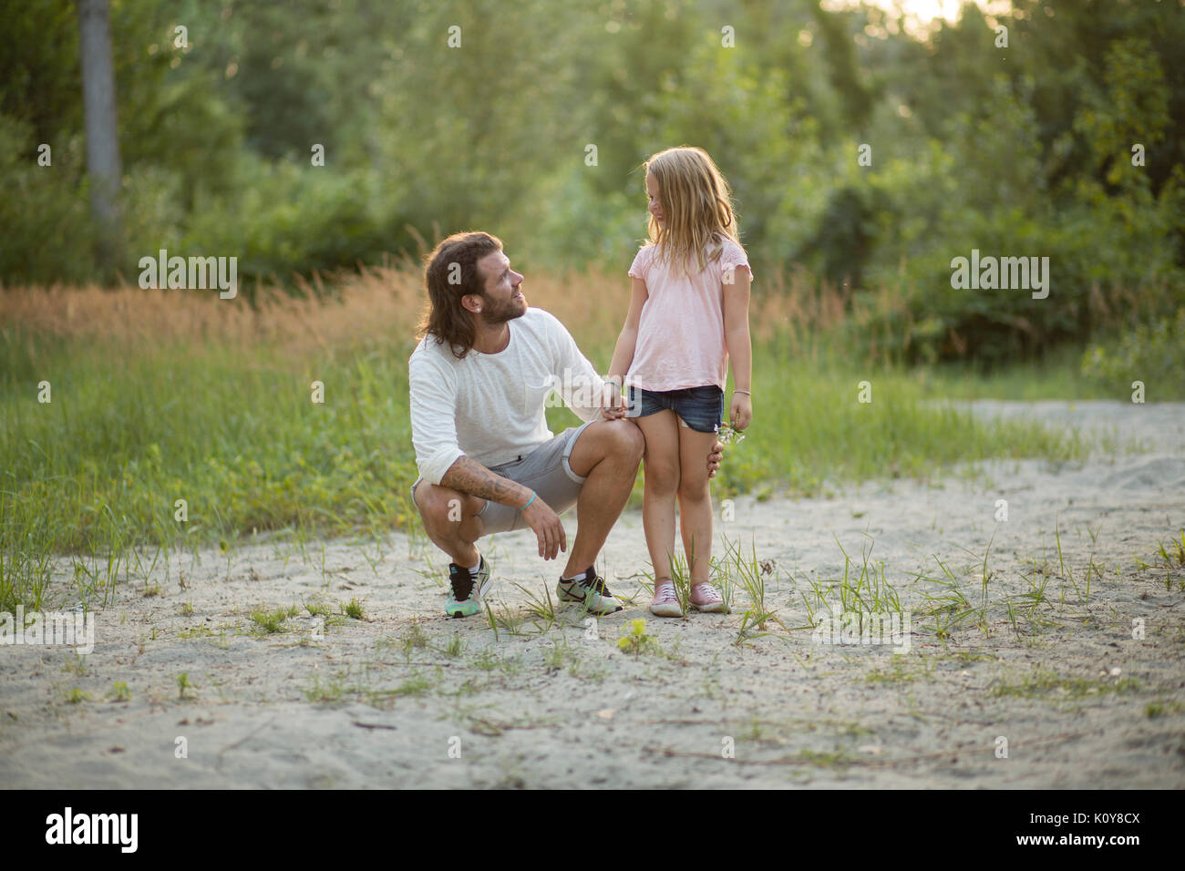 Father and daughter together in the forest Stock Photo - Alamy
