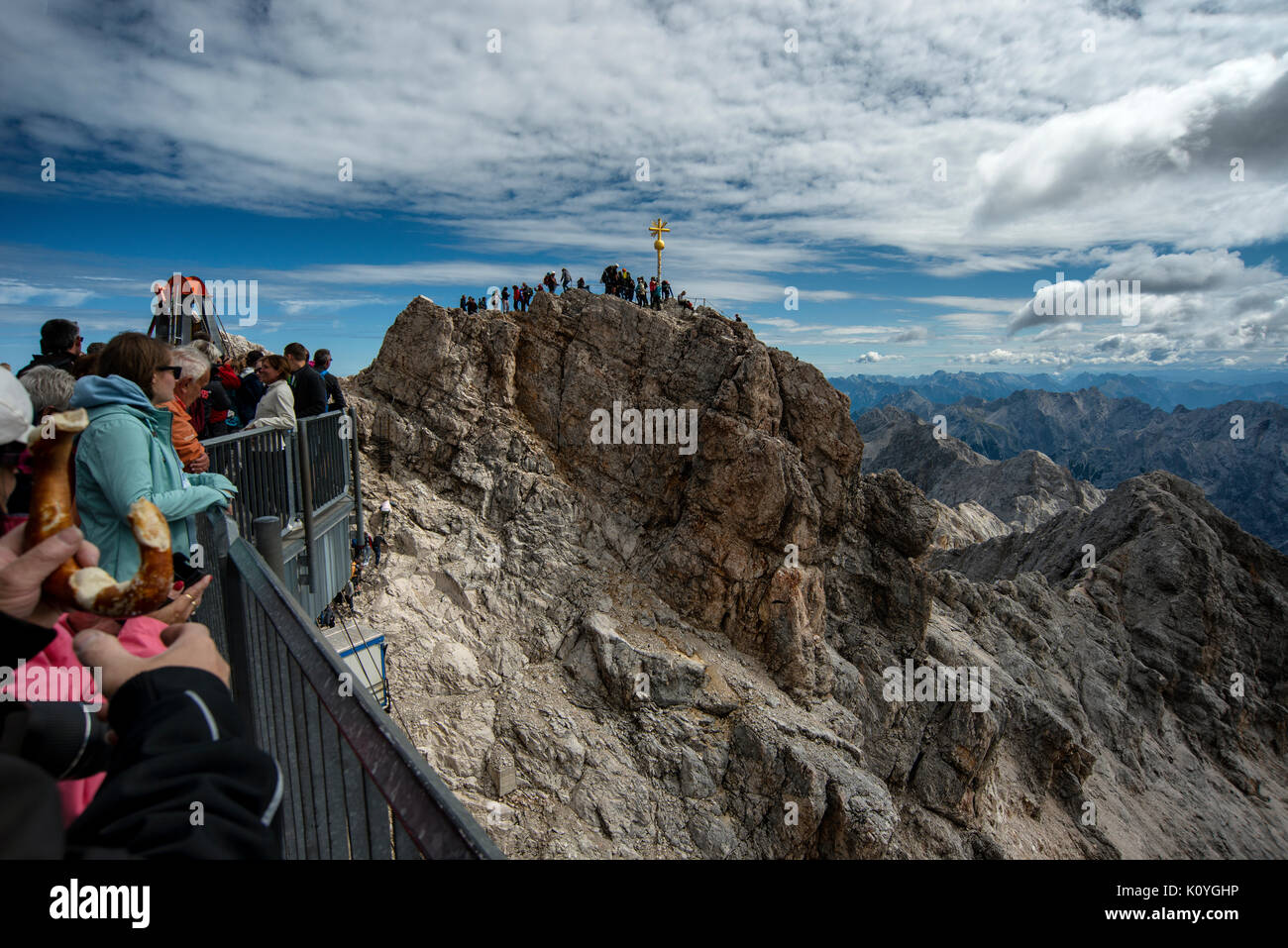 Tourists queue to get to the summit of the Zuspitze mountain on the Germany Austria border. At 2962m it is the highest mountain in Germany. Stock Photo
