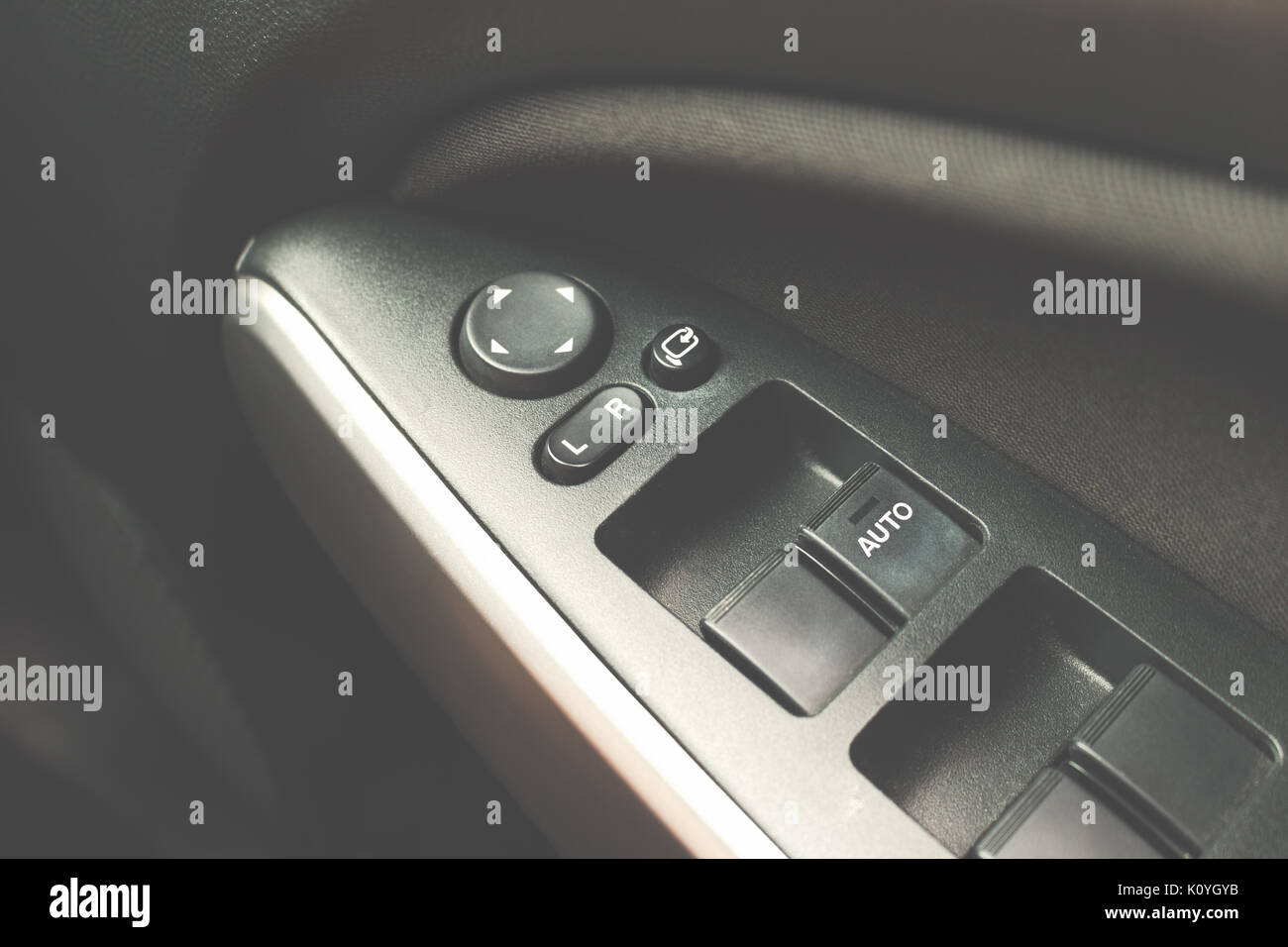 car interior details of door handle with windows controls and