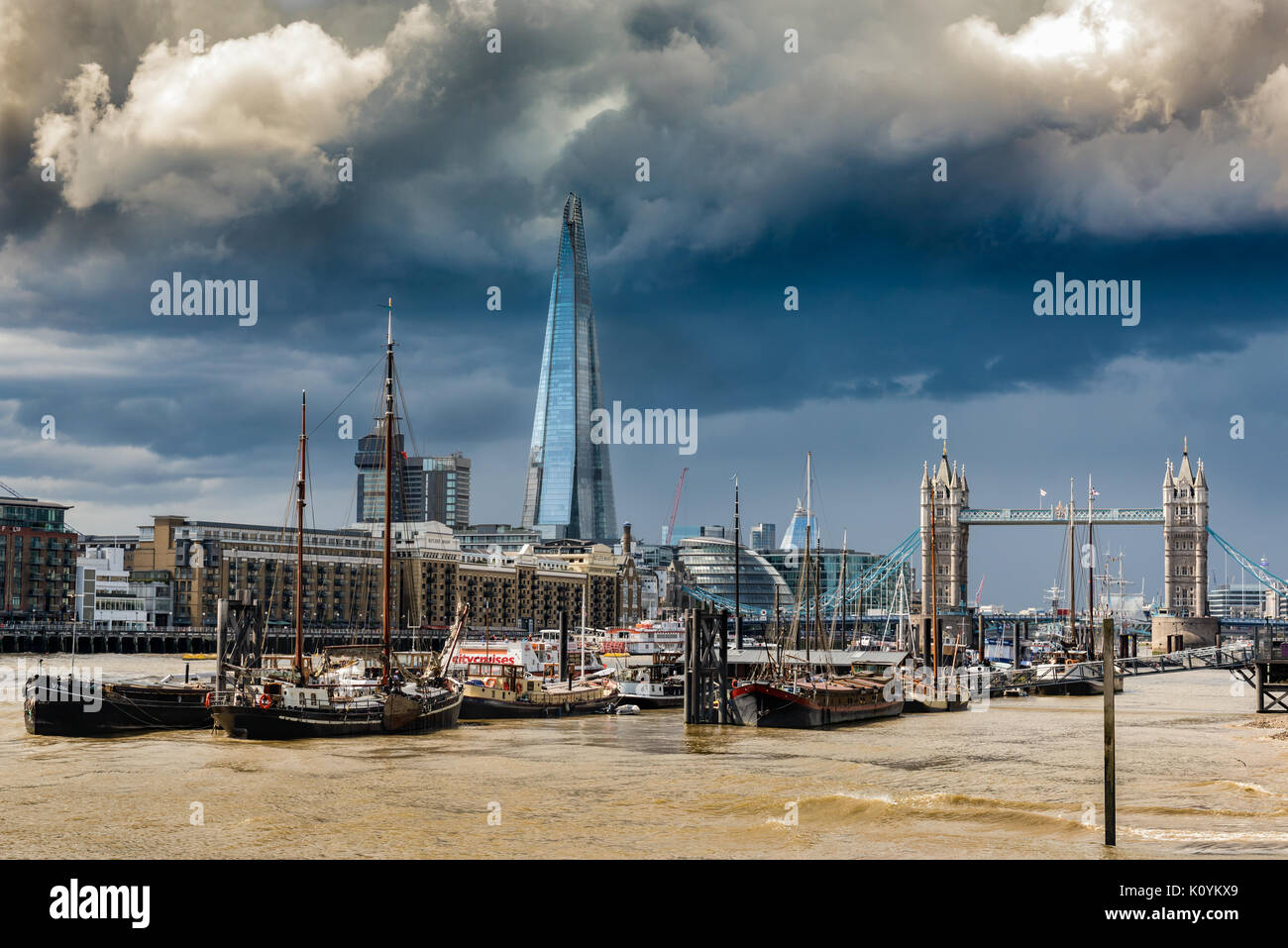 Thundery rain clouds roll down the River Thames through central London, threatening to deluge the East End. Stock Photo