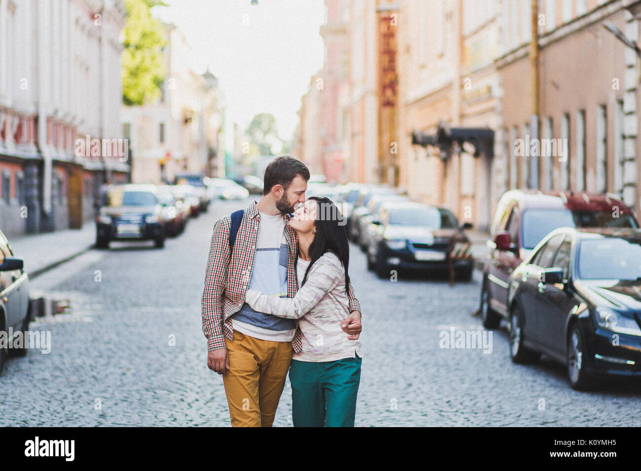 Young couple in casual style walking on city streets in old Saint-Peterspurg. Cheerful and happy Stock Photo