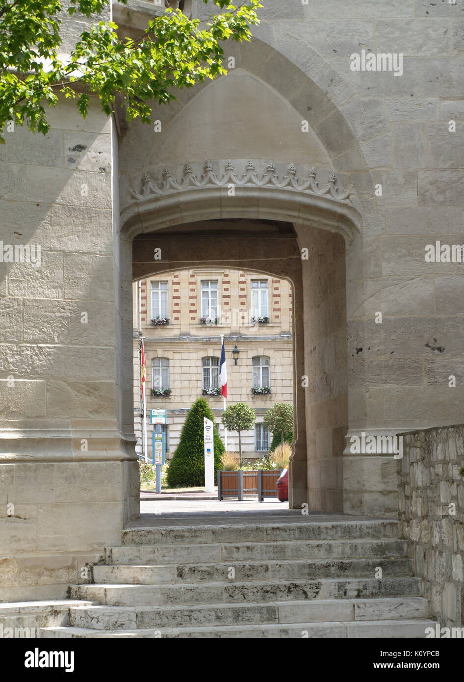 View towards Hotel De Ville through archway in clock tower in Evreux ...