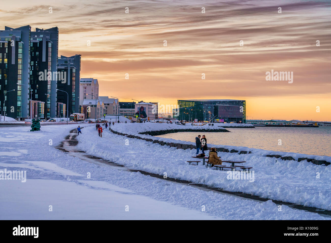 Walking path along the sea in the wintertime, Harpa in the backgrounsd Reykjavik, Iceland Stock Photo