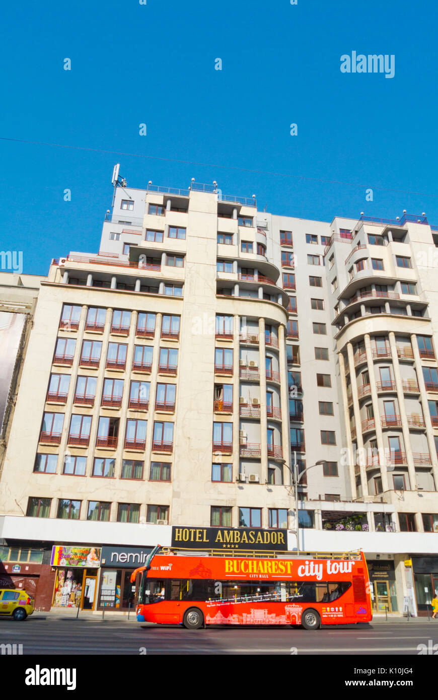 City sightseeing tour bus, passing Hotel Ambasador, Bulevardul General Gheorghe Magheru, Bucharest, Romania Stock Photo