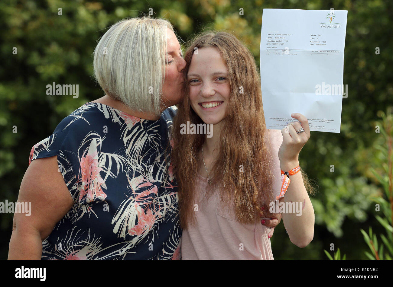 Millie Robson, 15, who was injured in the Manchester Bombings celebrates taking her GCSE English a year early, with her mother Marie, 43, at Woodham Academy in Newton Ayrcliffe. Stock Photo