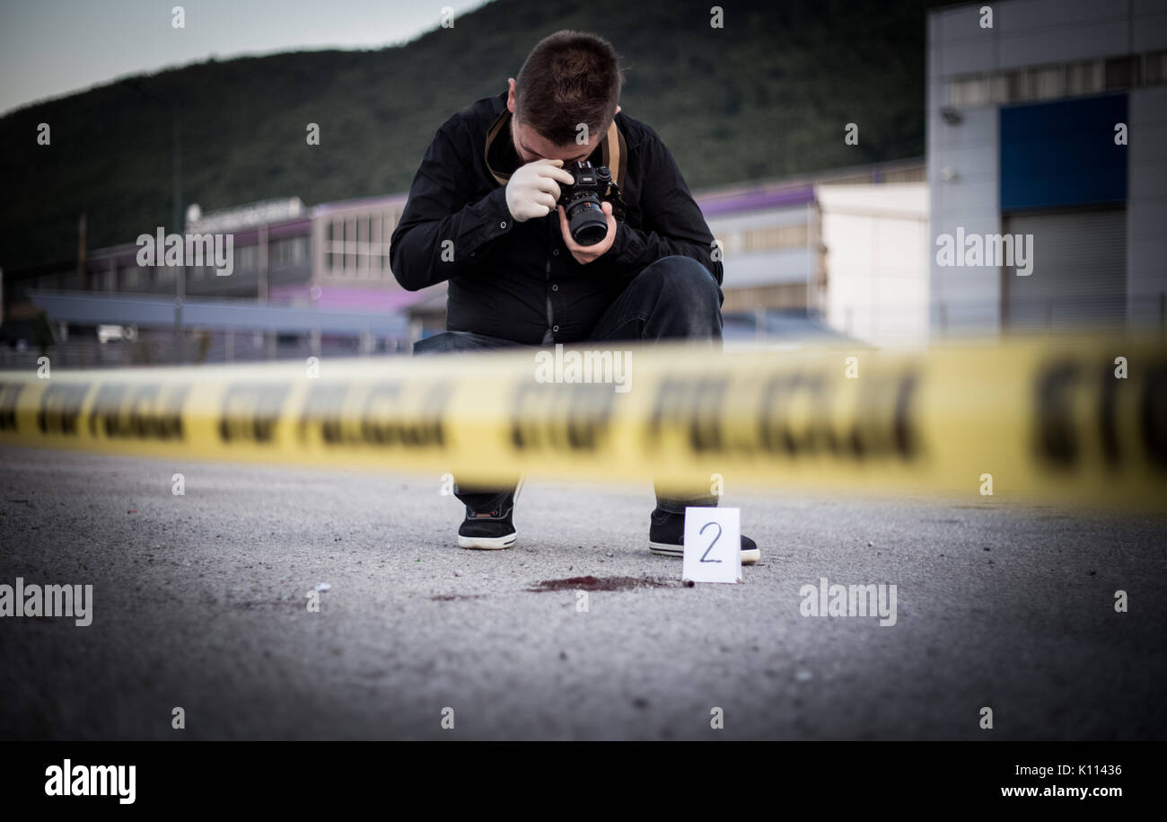 Crime scene, murder, investigation, bloody trail on asphalt, ongoing