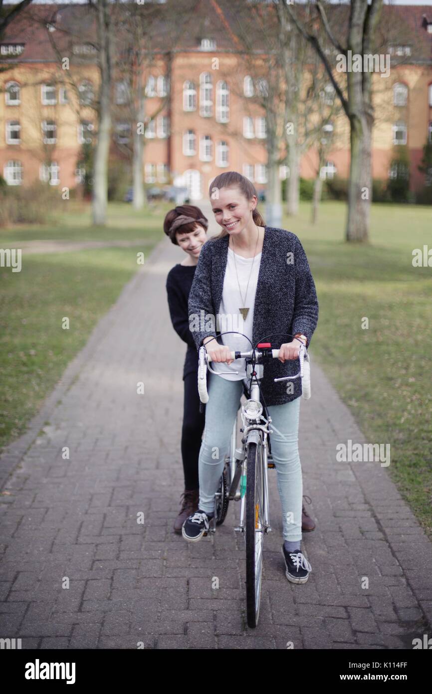 Two young women on a bicycle Stock Photo