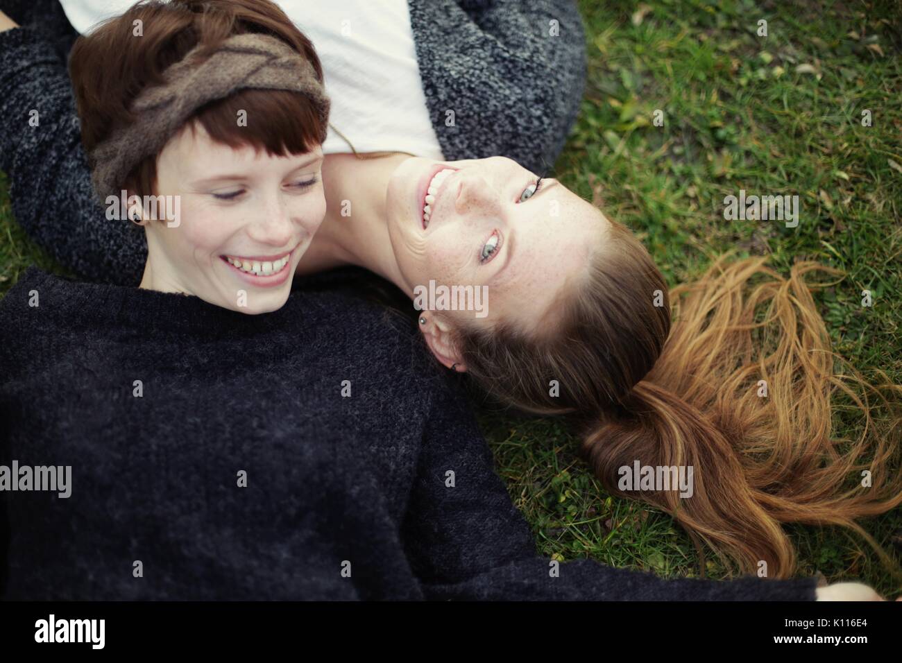 Two friends lying on a meadow Stock Photo