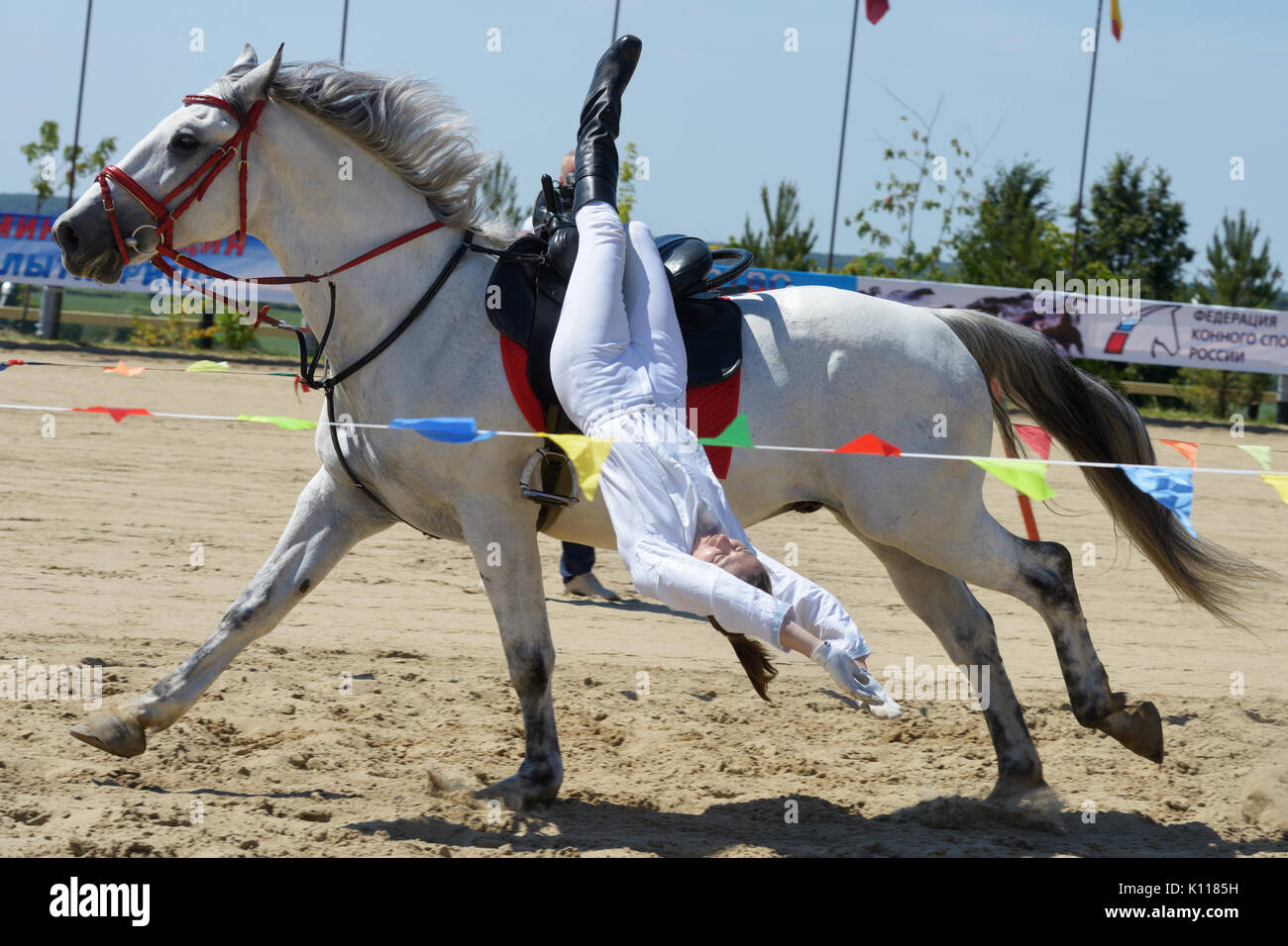 Lytkarino, Moscow region, Russia - July 12, 2014: Anna Rimashevskaya performs stunt during Russian championship in trick riding. Lytkarino housed the  Stock Photo