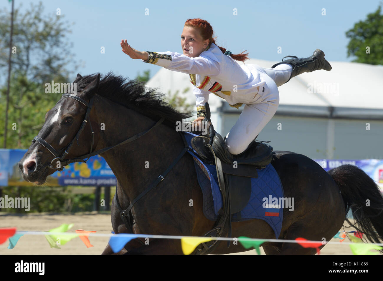 Lytkarino, Moscow region, Russia - July 12, 2014: Maria Kholodova performs stunt during Russian championship in trick riding. Lytkarino housed the Rus Stock Photo