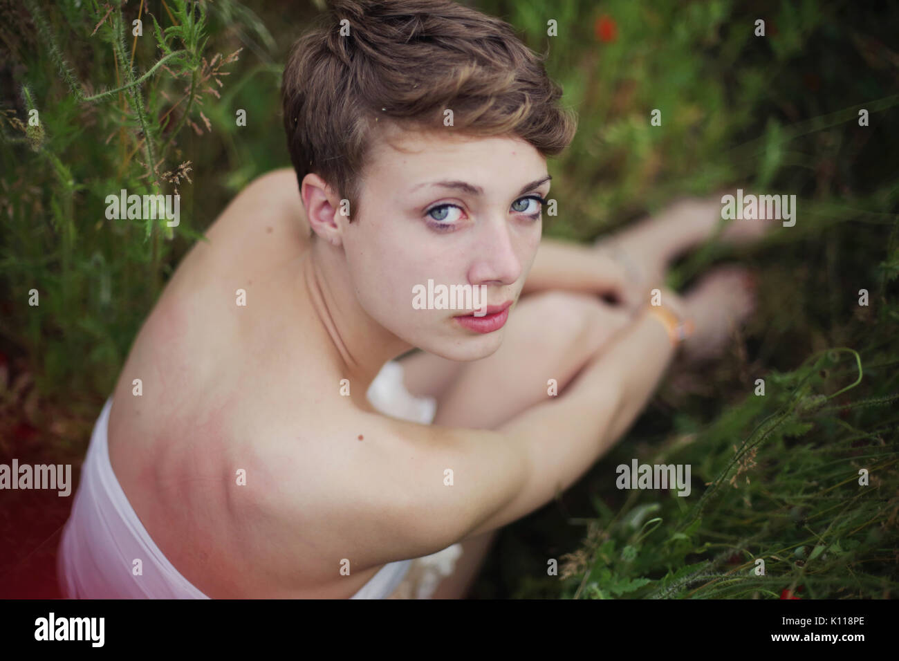 Young woman sitting on a meadow Stock Photo