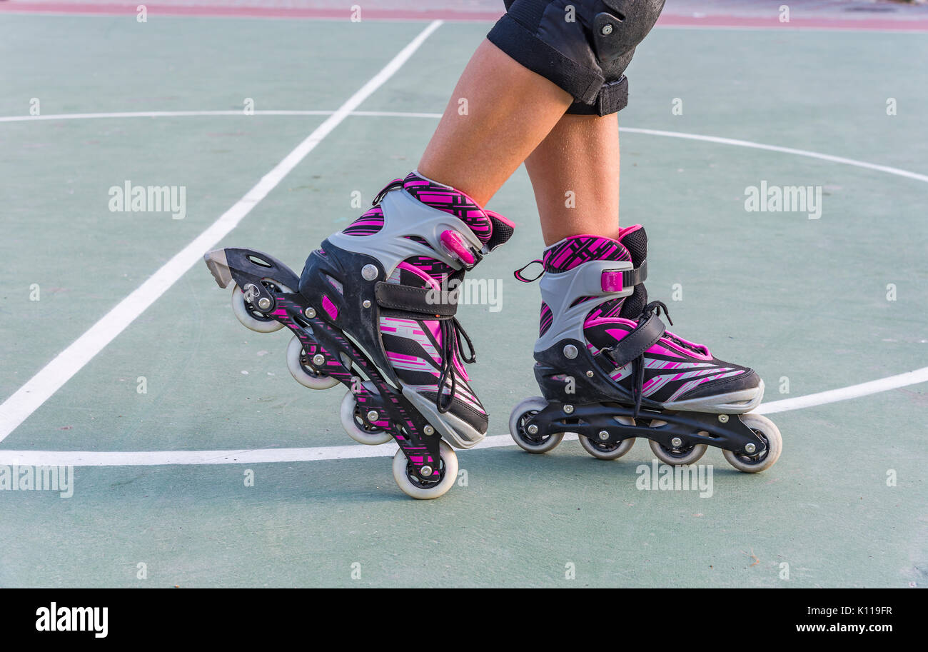 Roller skates feet closeup. Rollers on the legs of sports Stock Photo