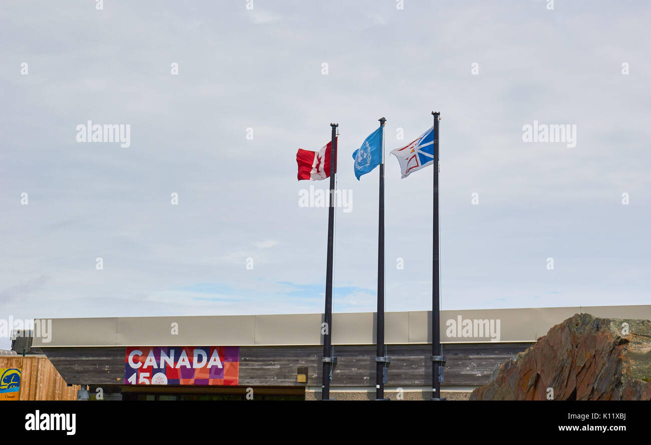Canadian, United Nations and Newfoundland and Labrador flags flying at the L'Anse Aux Meadows visitor centre, Newfoundland, Canada Stock Photo
