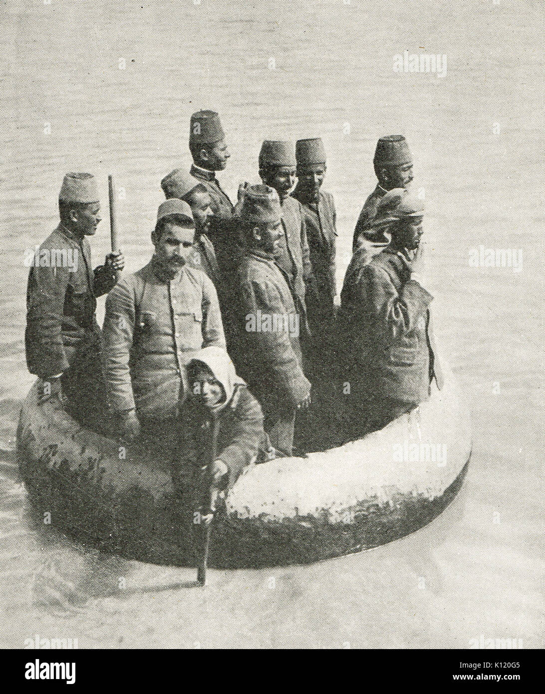 Turkish soldiers being ferried across a river in a Kuphar, Mesopotamian campaign, WW1 Stock Photo