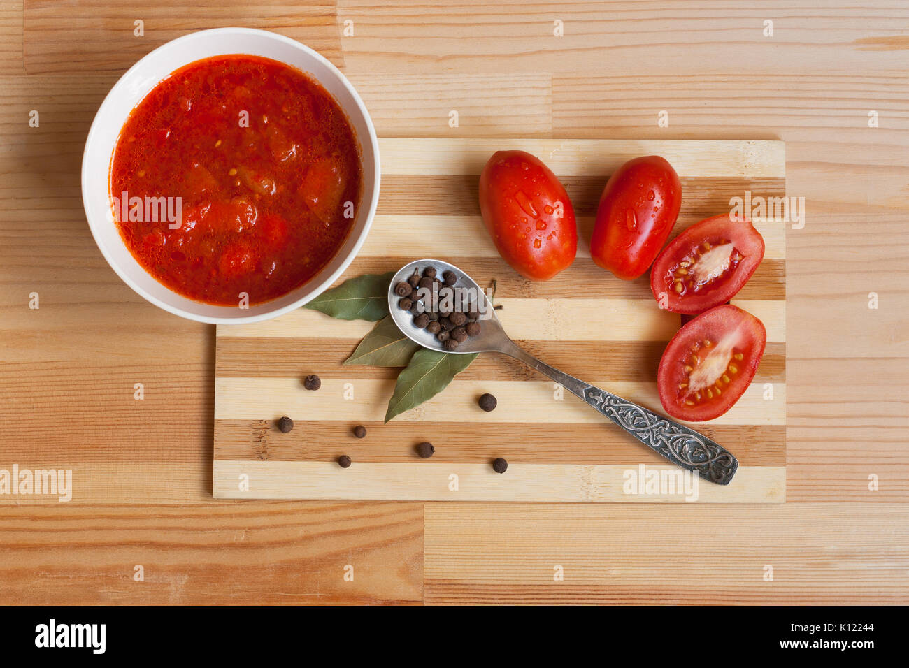 Tomato Sauce, Fresh Tomatoes, Bay Leaf And Spoon With Allspice On Wooden Table, Top View Stock