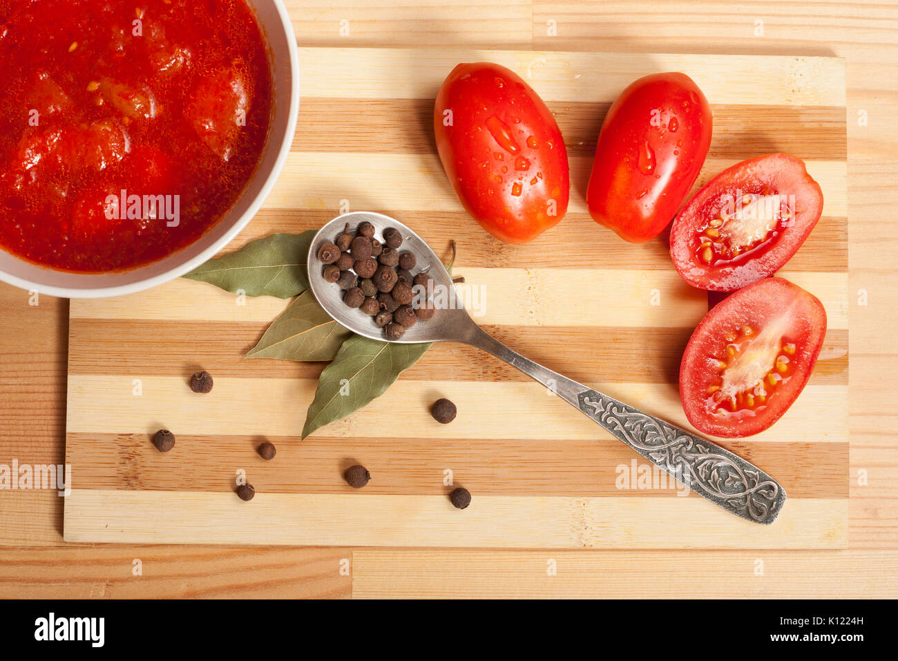 Tomato Sauce, Fresh Tomatoes, Bay Leaf And Spoon With Allspice On