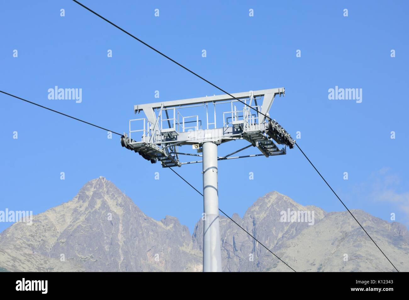 Chair lift mechanism with mountain in background Stock Photo Alamy