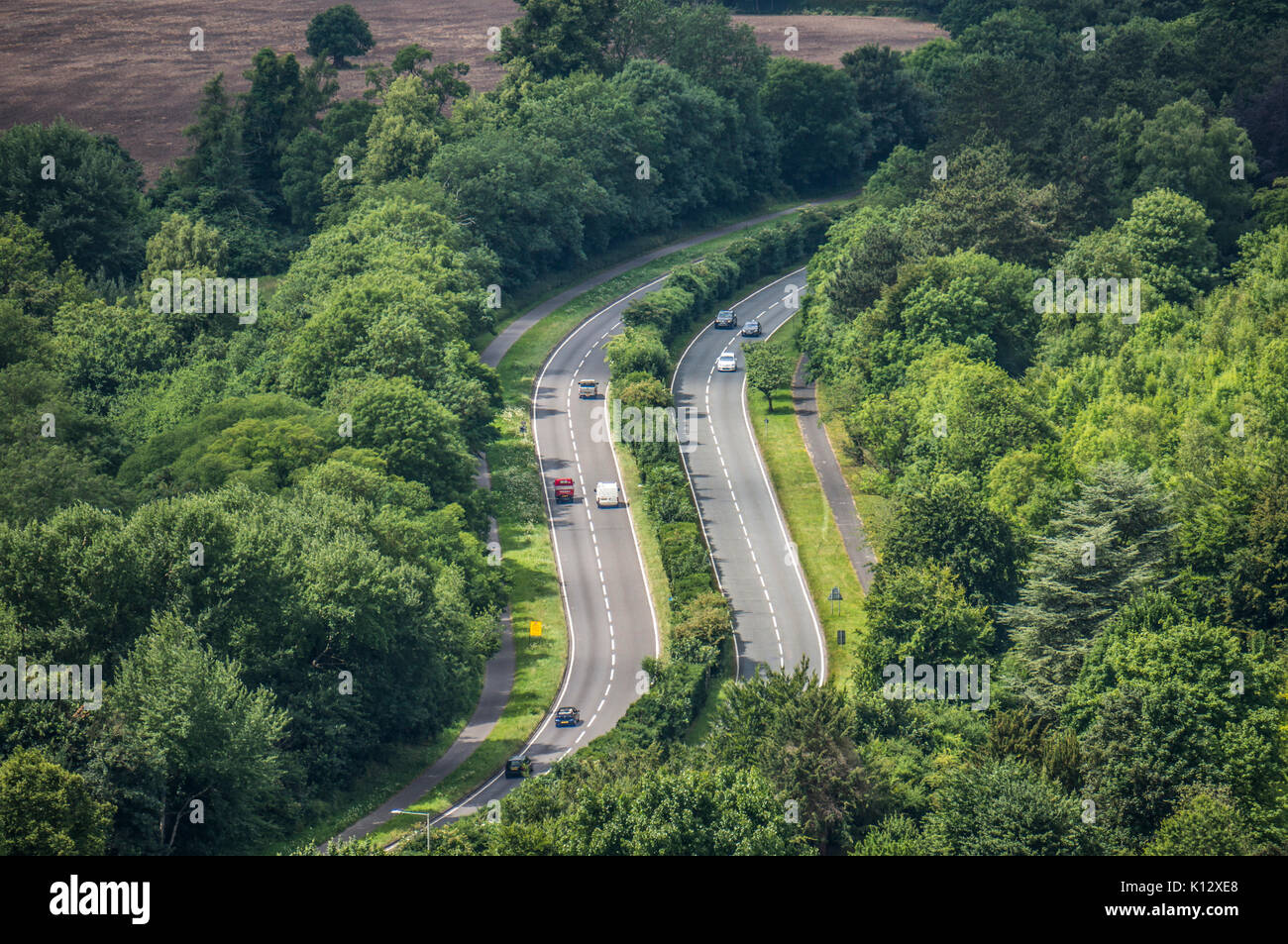 Taken from Box Hill in summer, traffic on bends in the dual carriageway, near Dorking, Surrey, England, UK. Stock Photo