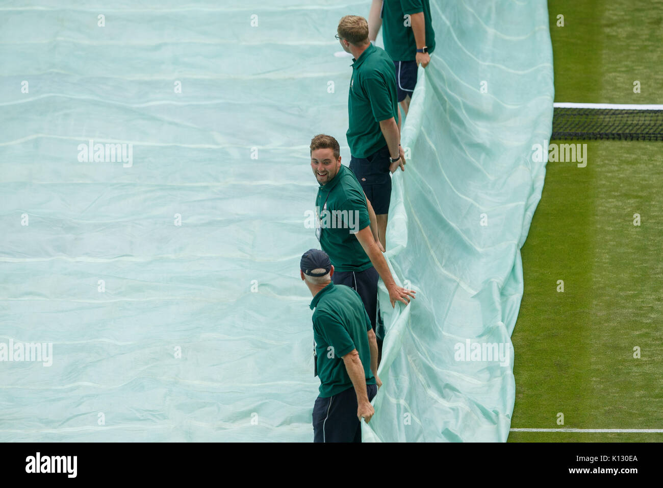 Ground Staff Pull A Rain Cover Off Court At The Wimbledon Championships ...