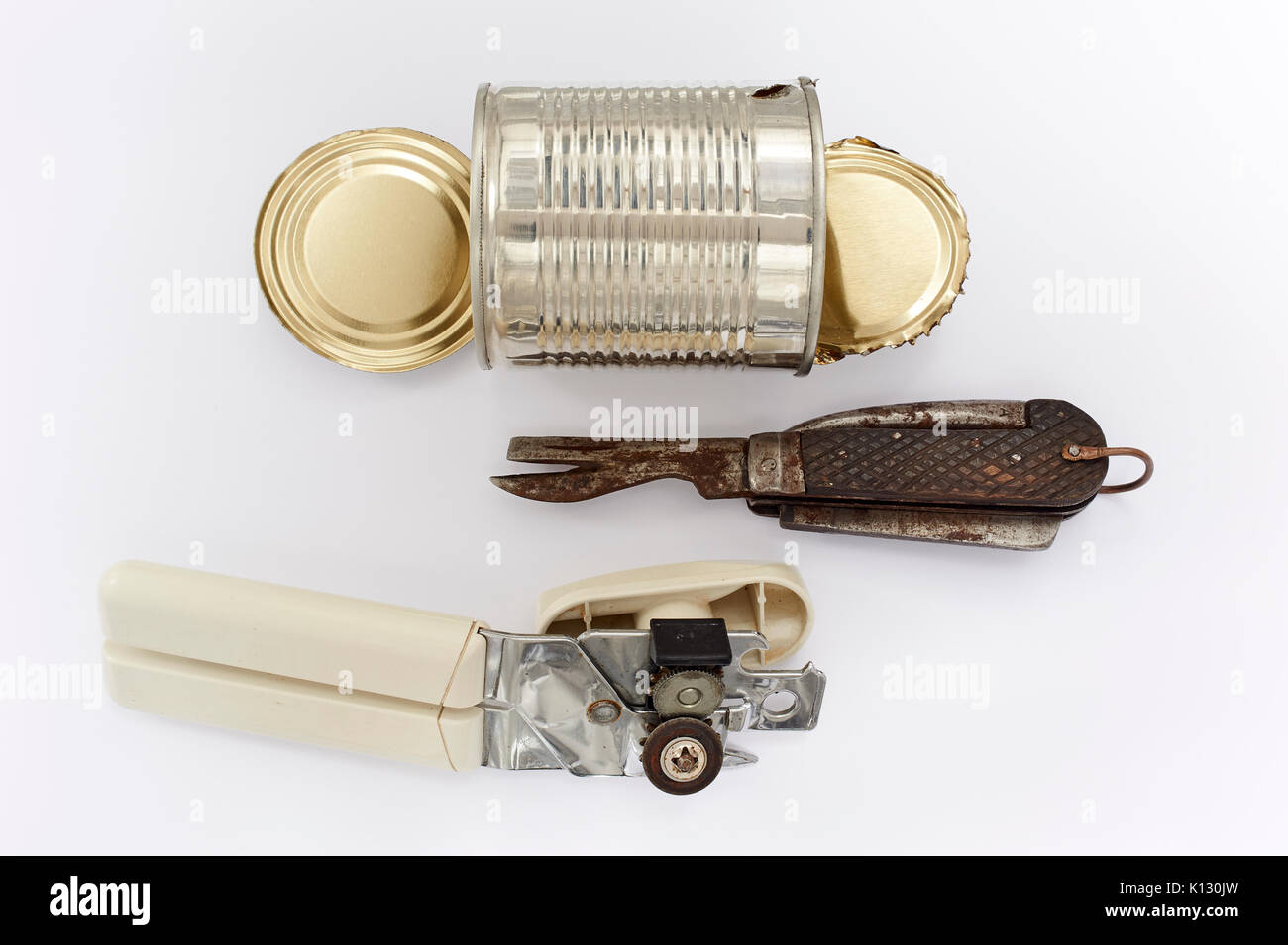 Can Openers - Results of a Can Opened by a WWI /II Forces Issue Knife and a Modern Can Opener Stock Photo