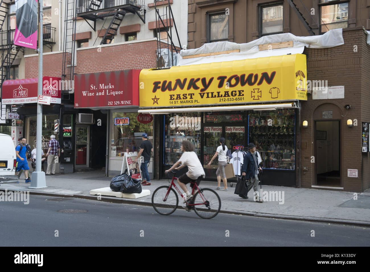 People walk along the still funky St. Mark's Place in the East Village in Manhattan, NYC. Stock Photo