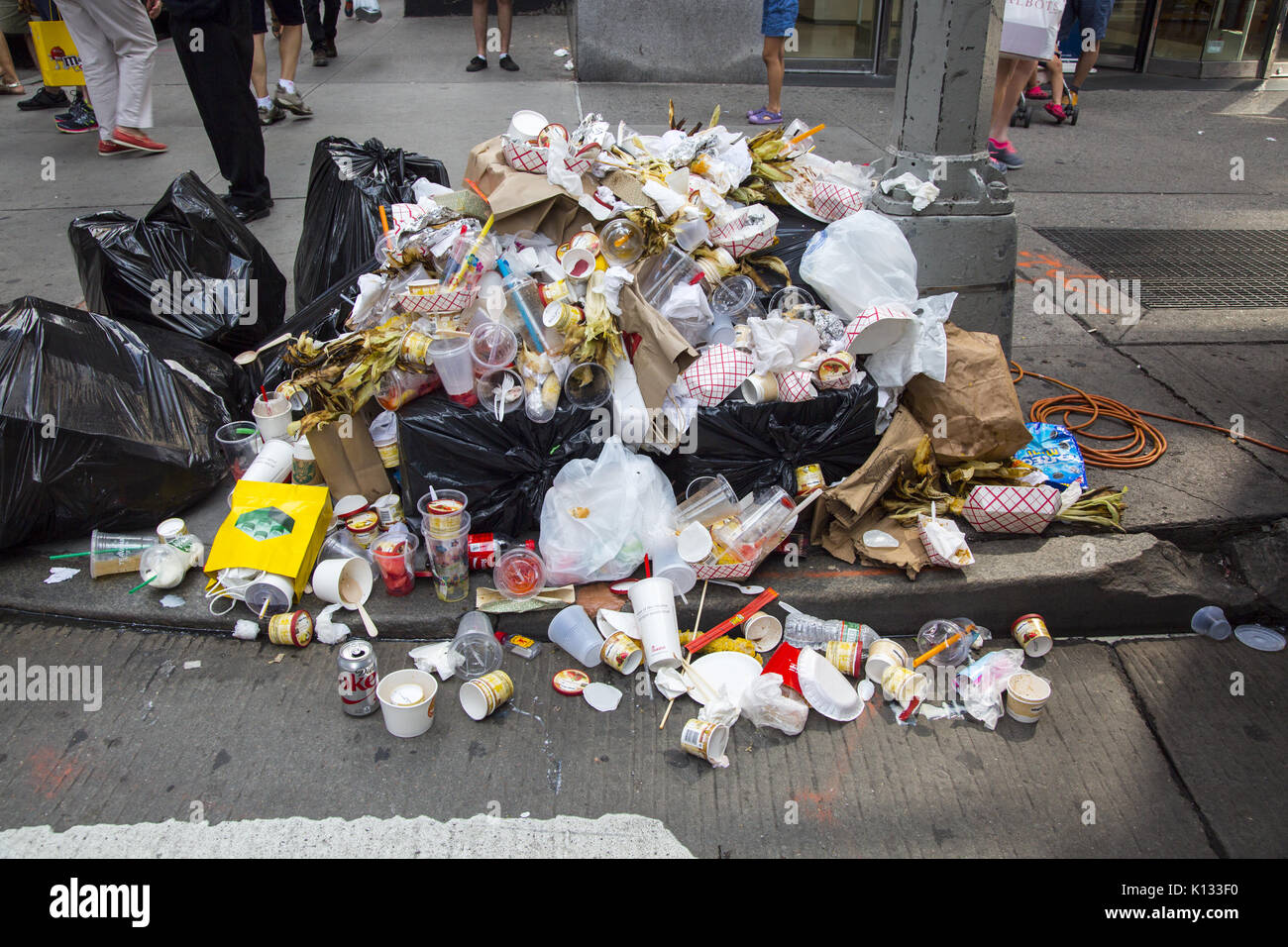 Overflowing garbage from foods and drinks sold at a street fair on Avenue of the Americas in