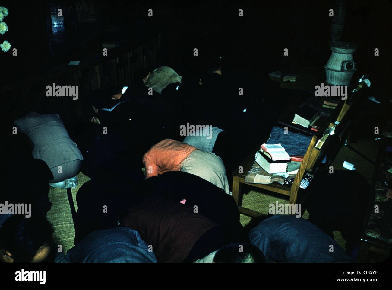 bent over  japan Japanese churchgoers bent over in prayer in a dark room in a Christian  missionary church, illuminated by a camera flash, Japan, 1951 Stock Photo -  Alamy