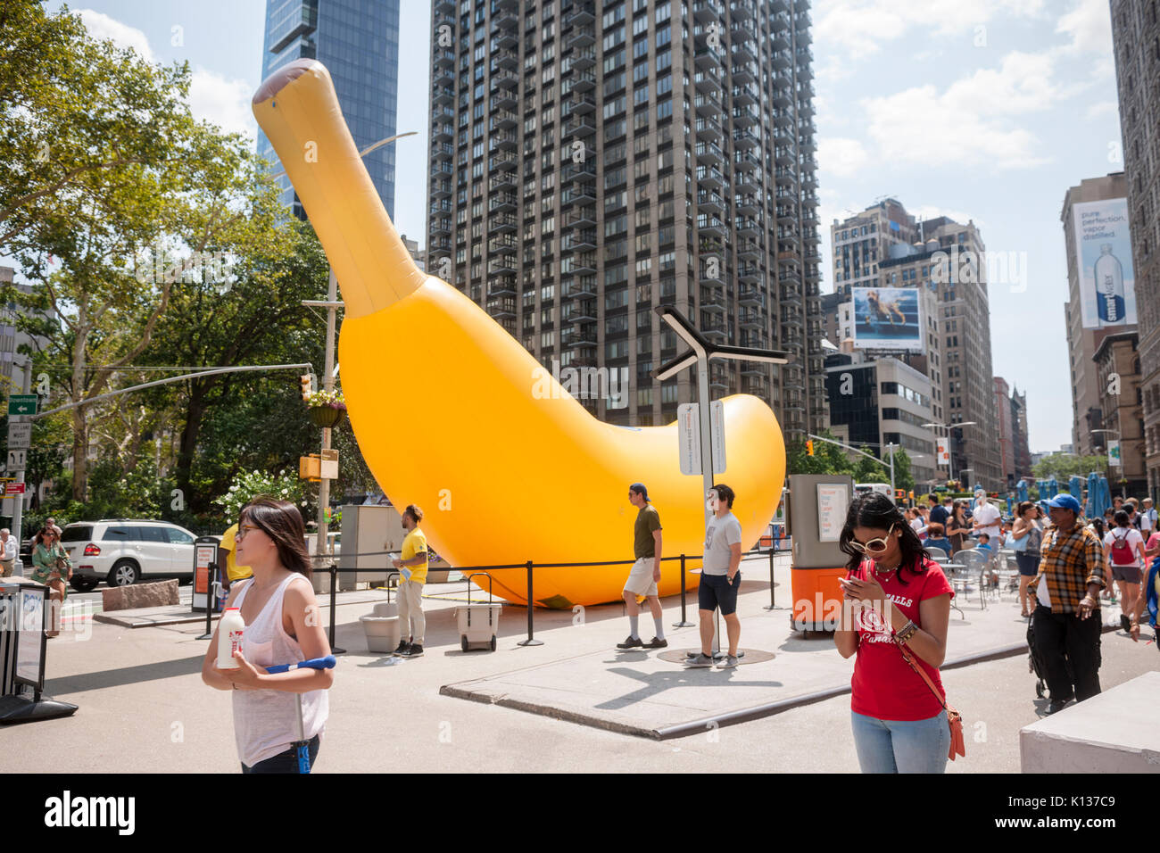A giant inflatable banana stands in Flatiron Plaza in New York on Sunday, August 20, 2017 as part of the Chiquita "Banana Sun" branding event. Chiquita has claimed the banana shaped sliver of the sun caused by the eclipse and re-named it the "Banana Sun", also claiming that they are responsible for the eclipse. The tongue-in-cheek branding event also featured free eclipse watching glasses to passer-by. (© Richard B. Levine) Stock Photo