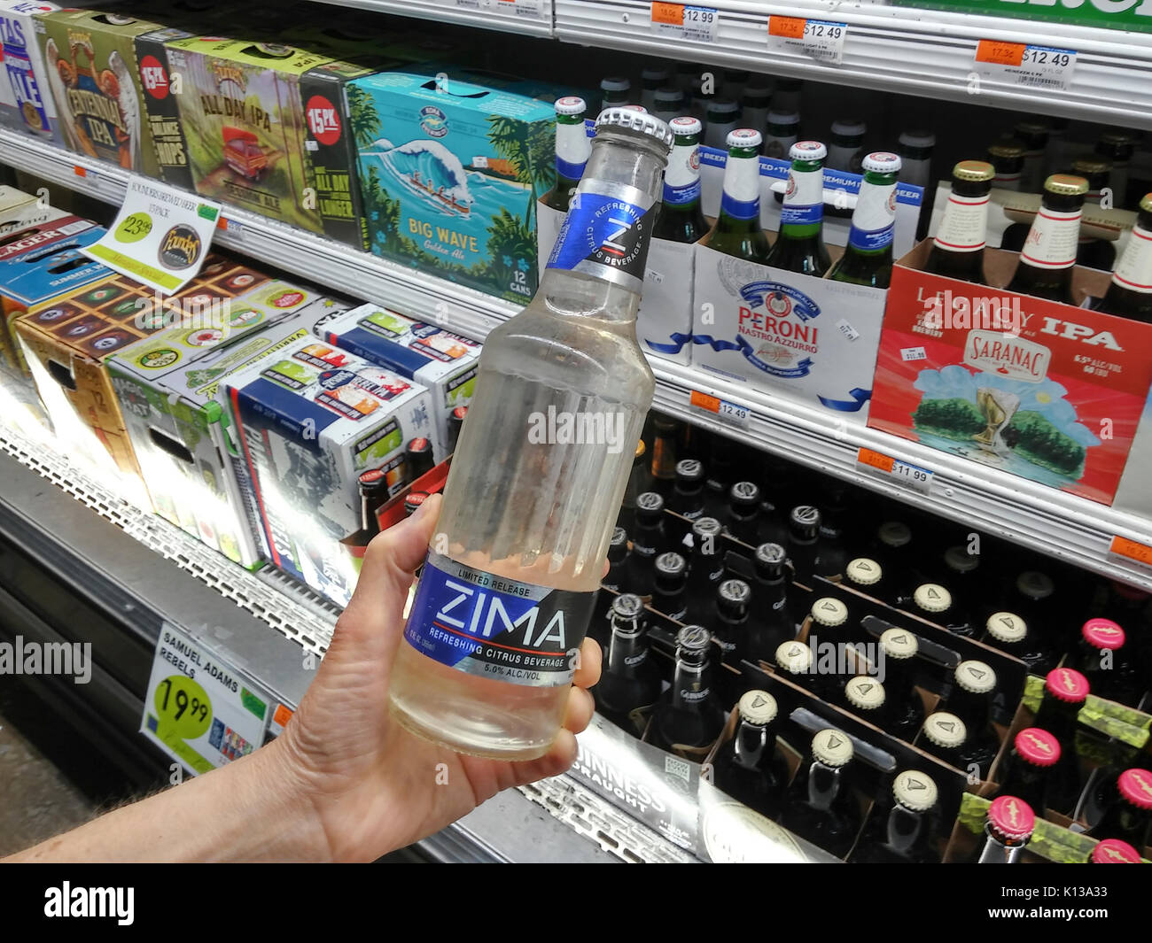A discerning consumer chooses a bottle of Zima alcoholic malt beverage in a grocery in New York on Tuesday, August 15, 2017. Originally released in 1993 production of the clear drink was stopped in 2008. This summer MillerCoors released the drink again on a limited basis. (© Richard B. Levine) Stock Photo