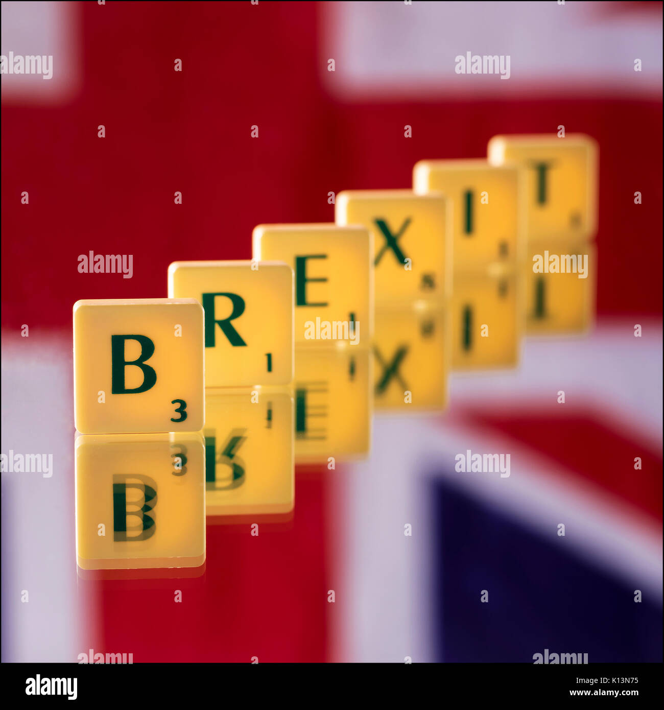 Everyone's favorite subject, Brexit!  Scrabble letters stood on a mirror with a Union Jack hung on the wall behind.   Strobist: monolight with a 7' re Stock Photo