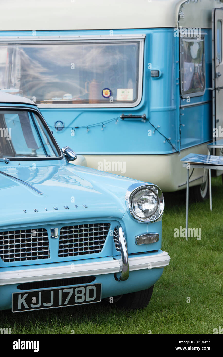 1966 triumph herald 1200 and a vintage caravan at a vintage retro festival. UK Stock Photo