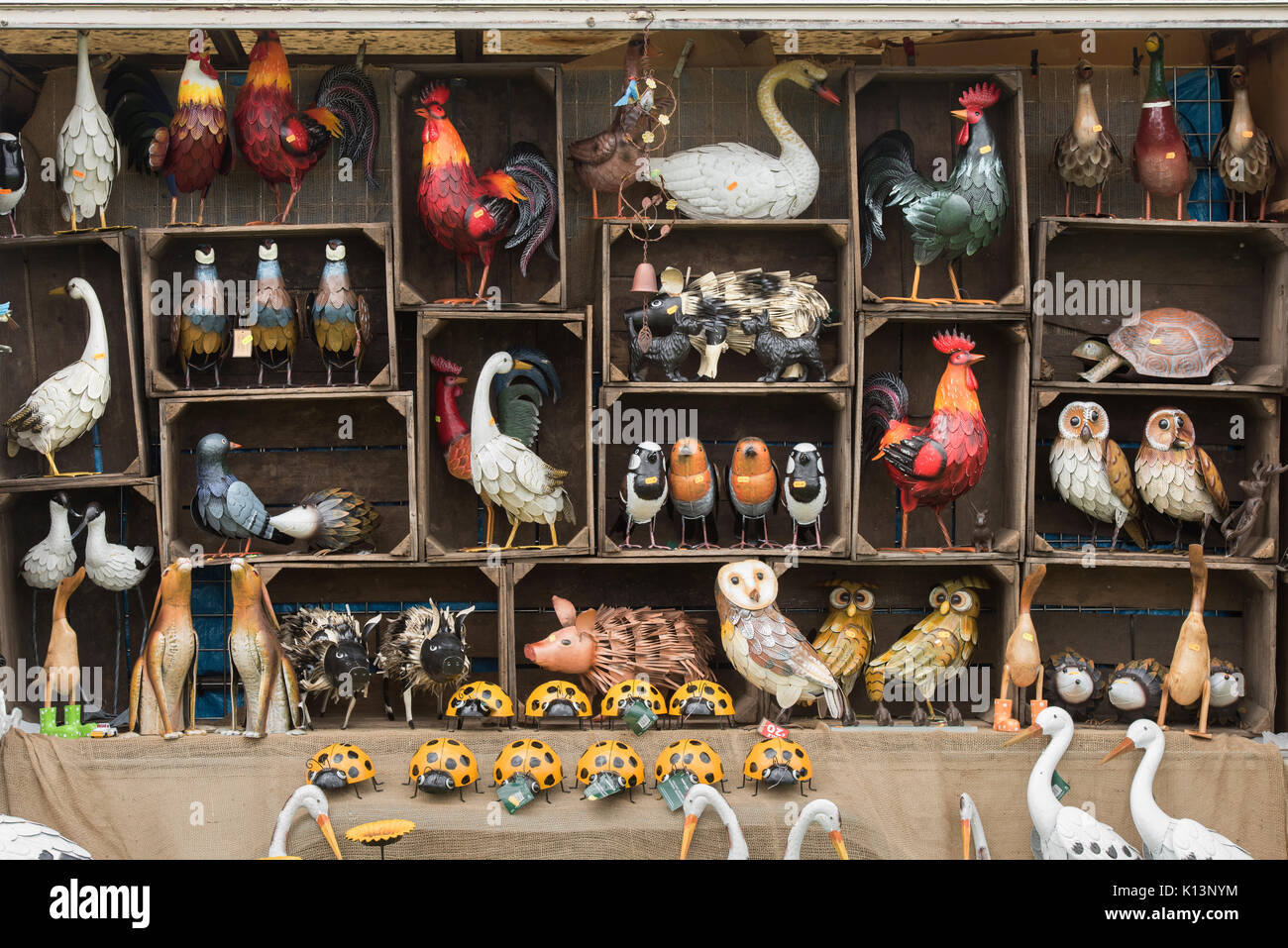 Craft metal birds and animals for sale on a market stall at a vintage retro festival. UK Stock Photo