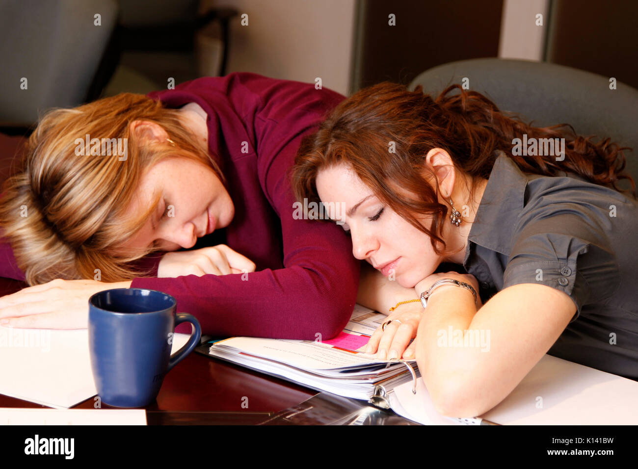 two tired employees take a nap break Stock Photo