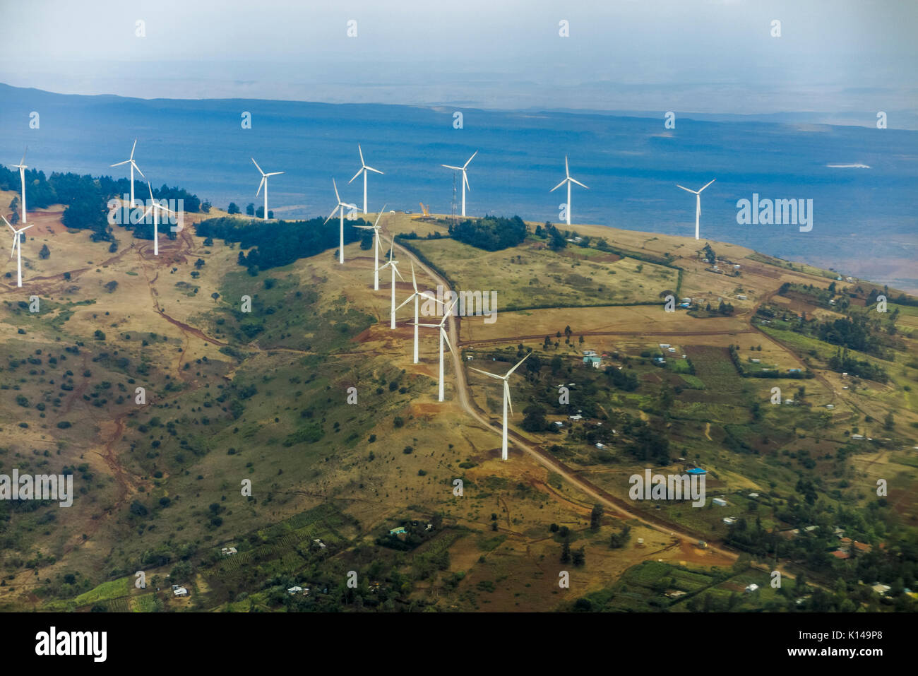 Panorama: wide-angle panoramic aerial view of landscape on the Masai Mara, Kenya with wind turbine power generators on the hillside Stock Photo