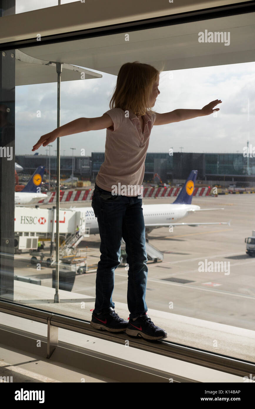 Children wave goodbye to departing aircraft at London Heathrow airport, Terminal 2. UK. (89) Stock Photo