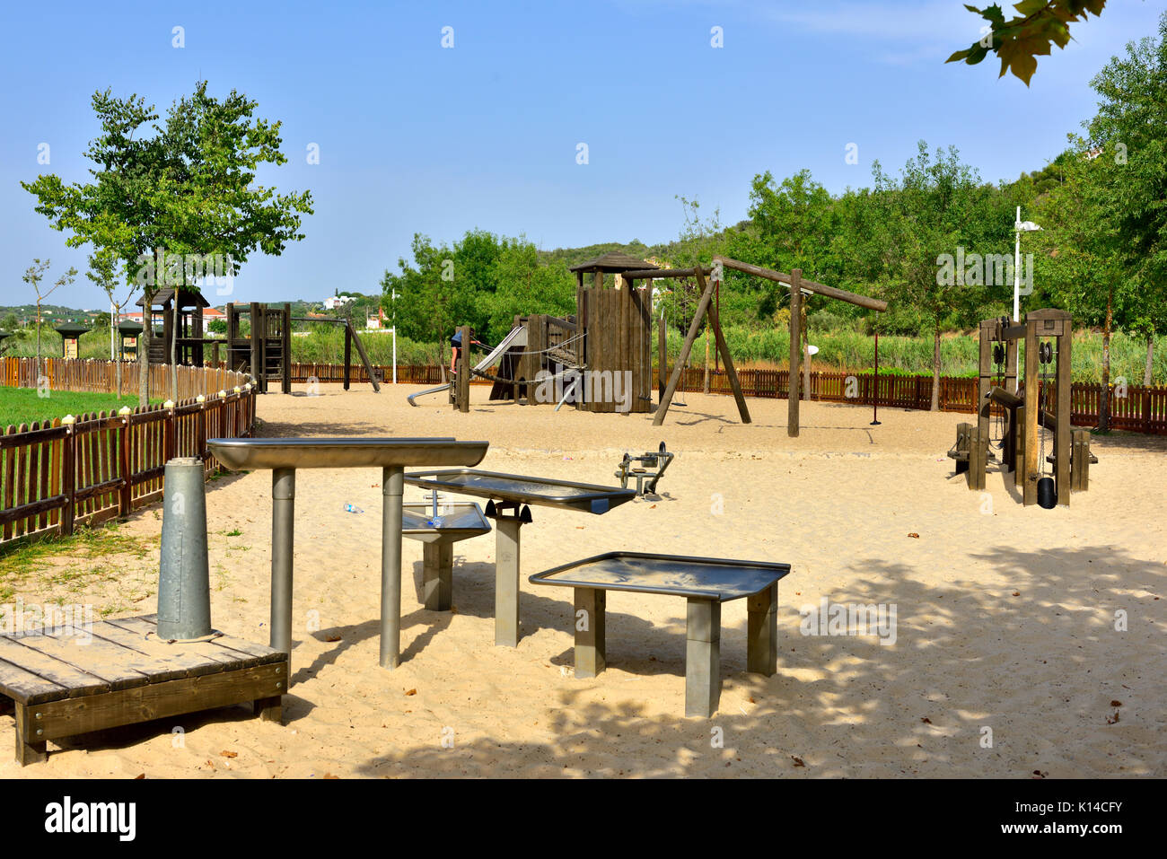 Outdoor adult exercise area adjacent to children's playground Stock Photo