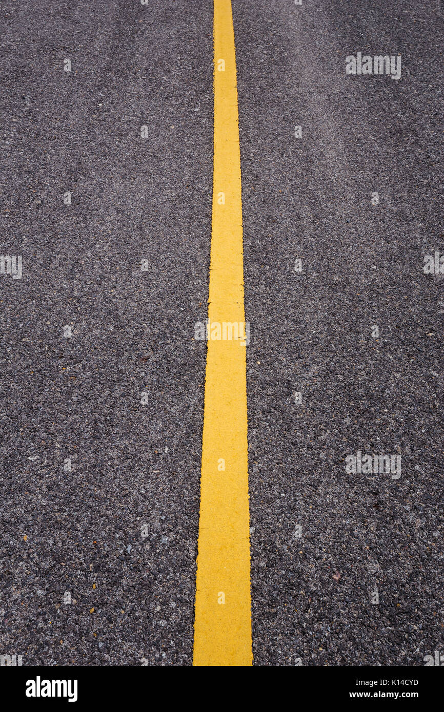 close up asphalt road with yellow line Stock Photo - Alamy