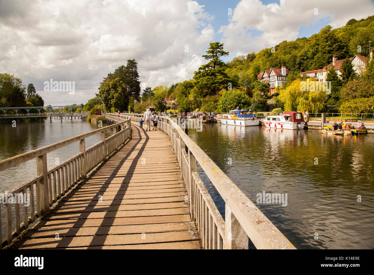 The Thames footpath as it passes over the river on a wooden footbridge at Marsh lock Henley on Thames Oxfordshire Stock Photo