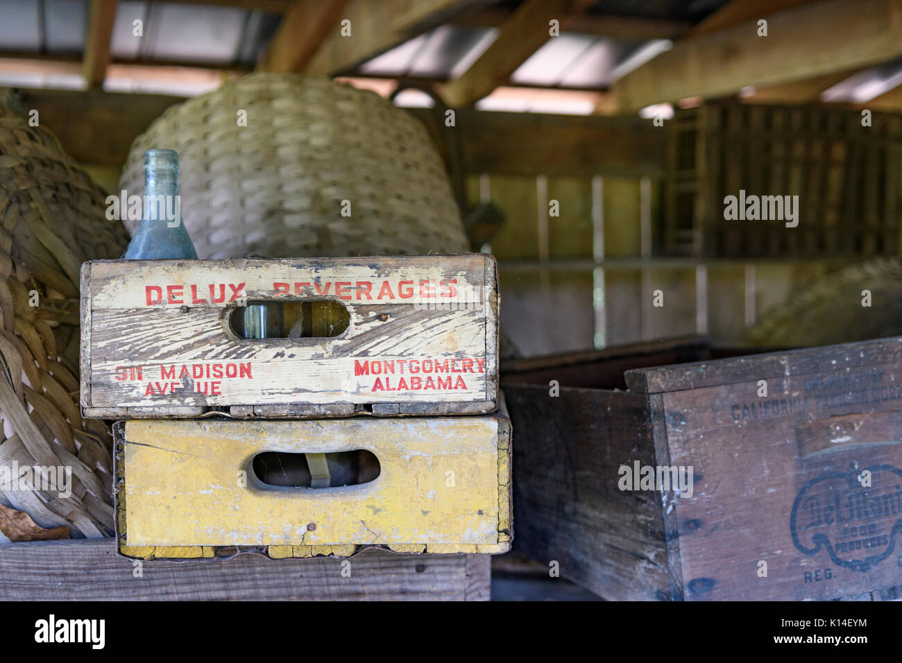 A Delux Beverages wooden crate among other vintage food and beverage crates stored in an old shed south of Montgomery, Alabama, USA. Stock Photo