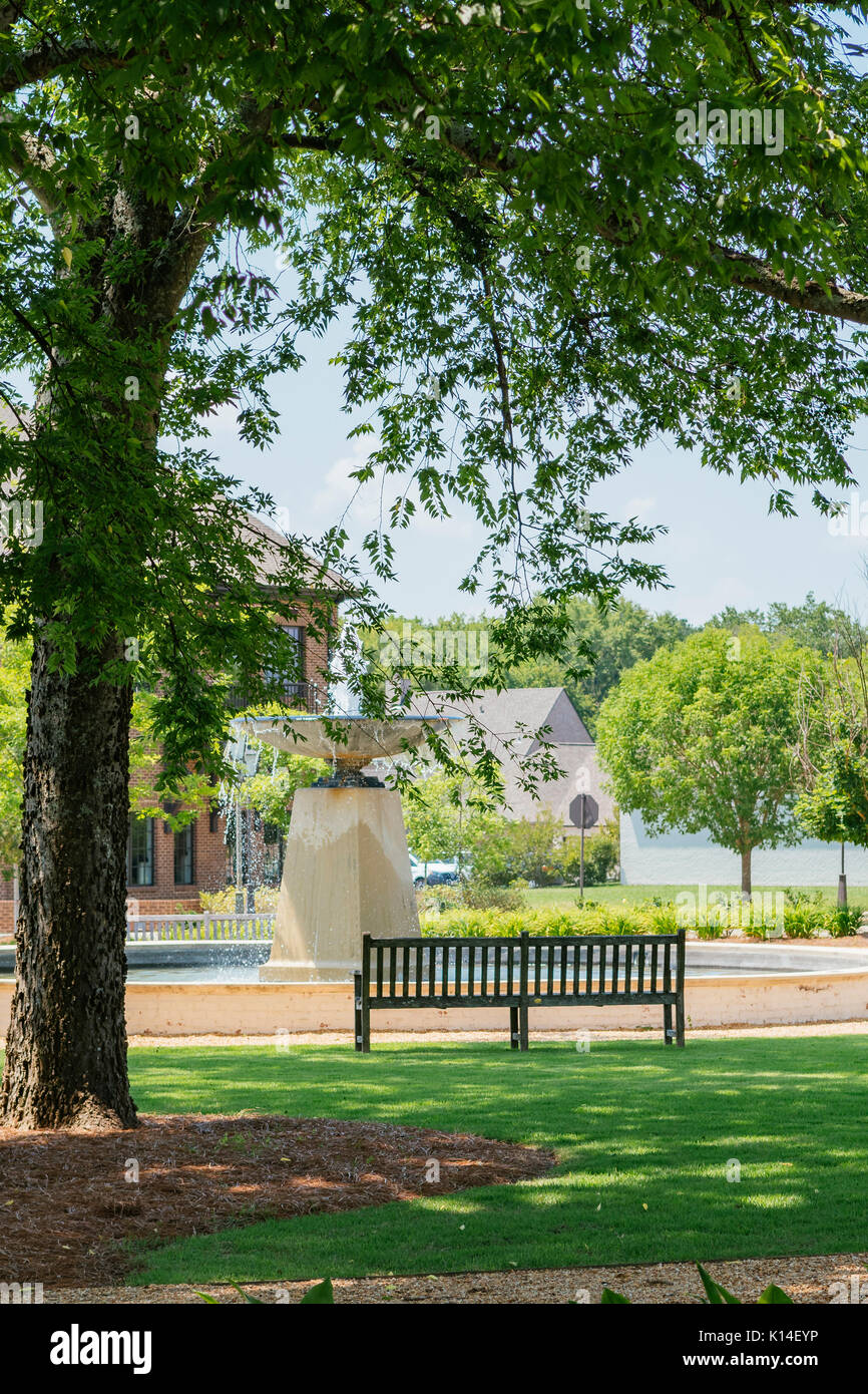 The neighborhood park in Hampstead community in the suburbs of Montgomery, Alabama, USA with a park bench and fountain. Stock Photo
