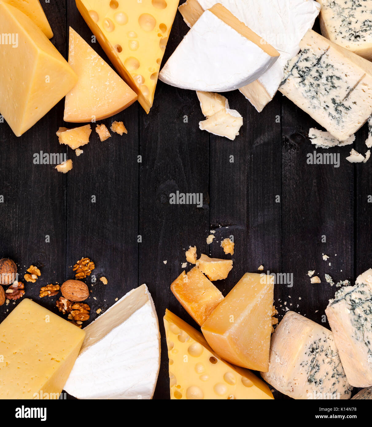 Frame of different types of cheese on black table Stock Photo