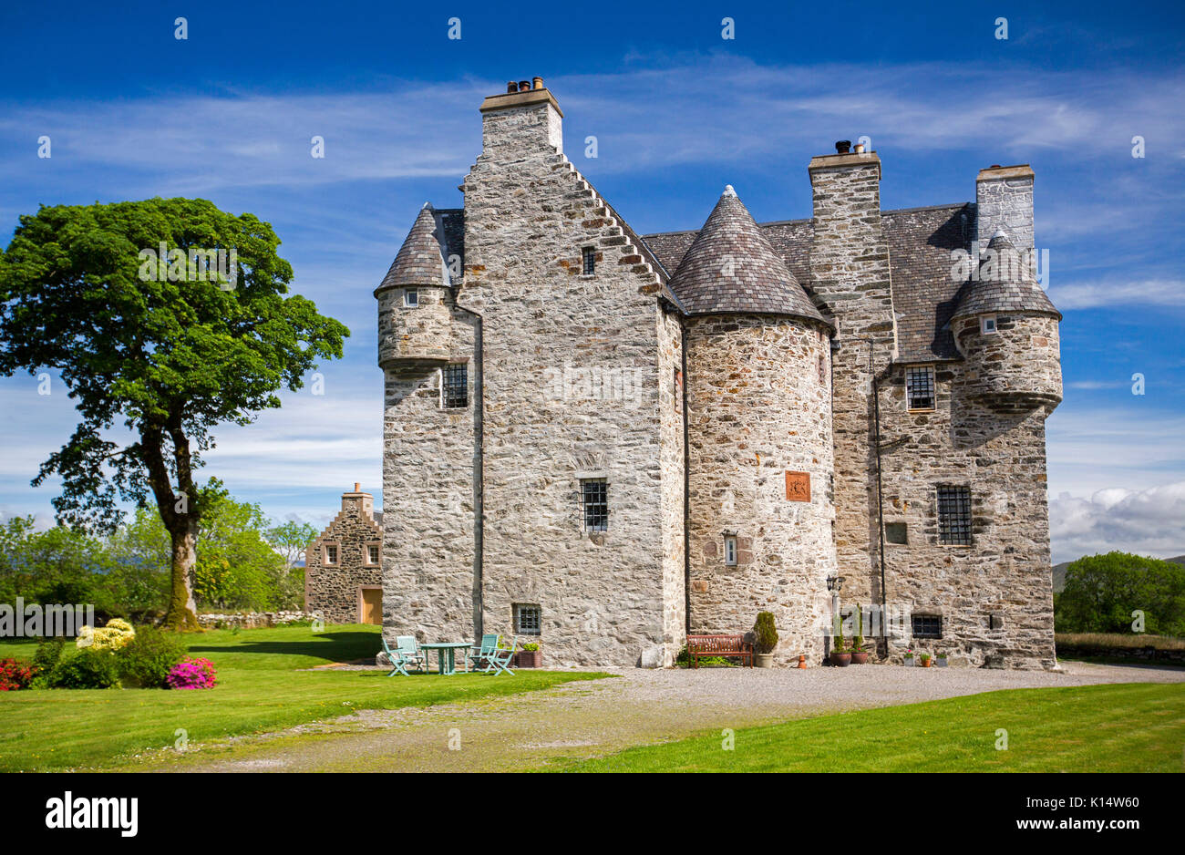Stunning view of 17th century Barcaldine castle, now a B & B / hotel accommodation surrounded by colourful  gardens under blue sky in Scotland Stock Photo