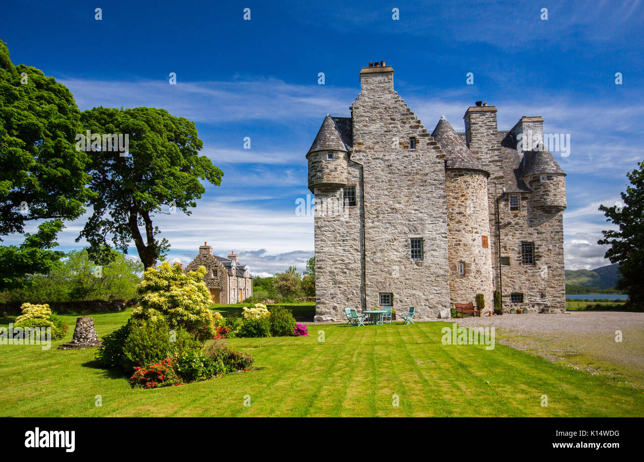 Stunning view of 17th century Barcaldine castle, now a B & B / hotel accommodation surrounded by colourful  gardens under blue sky in Scotland Stock Photo